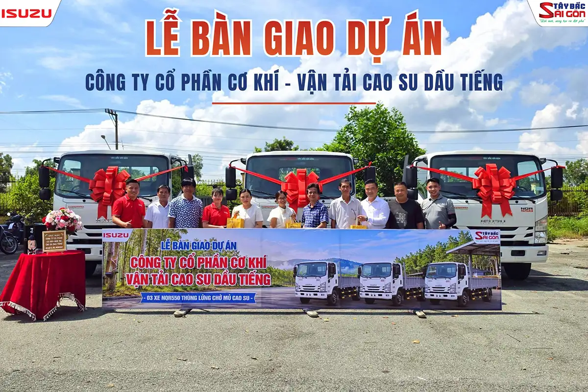 Lễ bàn giao 3 xe tải ISUZU NQR550 cho khách hàng doanh nghiệp, có nơ đỏ và banner ISUZU Tây Bắc Sài Gòn